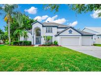 Beautiful two story home featuring manicured lawn, lush landscaping and a two car garage at 3170 Zaharias Dr, Orlando, FL 32837