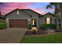 Charming home featuring a two-car garage, neutral paint, and a well-manicured lawn at 352 Alicante Ct, Davenport, FL 33837