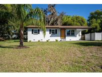 Charming single-story home with a freshly painted exterior and a well-manicured front yard at 453 E Jessup Ave, Longwood, FL 32750