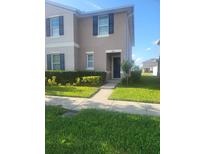 Inviting two-story home featuring neatly trimmed hedges and a well-manicured front lawn at 4819 Apple Blossom Ln, St Cloud, FL 34771