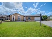 Charming single-story home featuring a well-manicured lawn and classic architectural details at 987 Trumbull St, Deltona, FL 32725