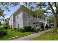 Charming two-story home features a beautiful balcony, landscaped yard, and inviting curb appeal at 1211 Celebration Ave # 102, Celebration, FL 34747