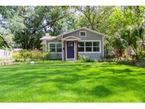 Charming single-story home featuring a well-manicured lawn, beautiful landscaping and a welcoming entryway at 1407 Noble Pl, Orlando, FL 32801