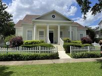 Charming home with a white picket fence and well-manicured landscaping offers classic curb appeal at 204 Celebration Blvd, Celebration, FL 34747