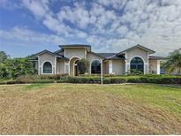 Stunning home with a well-manicured lawn and beautiful landscaping creating great curb appeal at 2150 Emperor Dr., Kissimmee, FL 34744