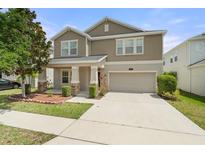 Charming two-story home with landscaped yard, neutral paint and attached two car garage at 3138 Dark Sky Dr, St Cloud, FL 34773