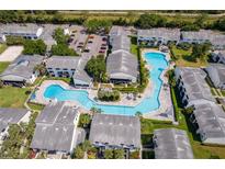 An aerial view showcasing a large community pool surrounded by well-maintained condominium buildings at 4403 S Semoran Blvd # 2, Orlando, FL 32822
