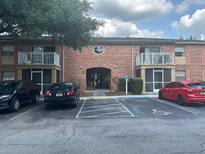 Brick building featuring second story balconies and convenient parking at 492 Banyon Tree Cir # 204, Maitland, FL 32751