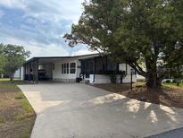 Charming single Gathering home with covered parking and mature shade tree at 503 Tivoli Park Dr, Davenport, FL 33897