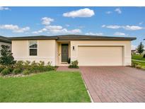 Charming single-story home featuring a brick driveway and attached two car garage at 527 Amadoras Way, St Cloud, FL 34771