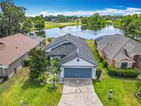 Beautiful single-Gathering home with lush lawn, mature trees, and stunning lake view at 550 Canary Island Cir, Davenport, FL 33837