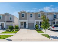 Charming townhome featuring a well-manicured lawn, driveway, and attached one car garage at 7728 Stone Creek Trl, Kissimmee, FL 34747