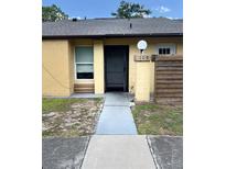 Inviting front entrance of the home with well-kept walkway and visible house number at 108 Creekside Way, Orlando, FL 32824