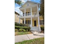 Charming two-story home with a spacious porch and manicured landscaping offers curb appeal at 1115 Mosaic Dr, Celebration, FL 34747