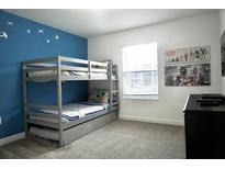 Charming bedroom featuring a bunk bed, Star Wars themed decor, and a bright blue accent wall at 1160 Kingsbarn St, Davenport, FL 33896