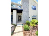 Inviting front entrance with modern design elements and well-maintained landscaping, creating a welcoming curb appeal at 1160 Kingsbarn St, Davenport, FL 33896