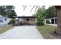 Charming single story home with well-maintained lawn and covered parking at 143 Piedmont Park Ave, Davenport, FL 33897