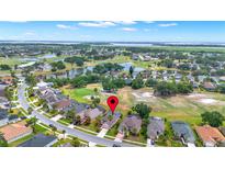 Expansive aerial view of home on golf course with mature trees and beautiful lakes at 1560 The Oaks Blvd, Kissimmee, FL 34746