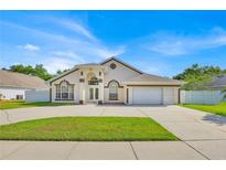 Charming single-story home boasts well-maintained lawn, arched entryway, and a two-car garage at 2642 Gild Dust Cir., Kissimmee, FL 34744