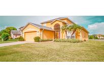 Charming two-story home boasting a well-manicured lawn, lush landscaping, and a two-car garage at 2650 Patrician Cir, Kissimmee, FL 34746