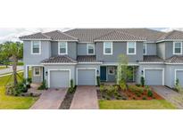 Charming multi-Gathering home features a well-maintained exterior, attached garages, and manicured landscaping at 3575 Landing Net Dr, Kissimmee, FL 34746