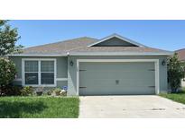 Charming single-story home featuring a two-car garage and well-maintained landscaping at 369 St Georges Cir, Eagle Lake, FL 33839