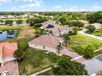 Areal view of a single Gathering home with a brick roof and well-manicured lawn in a desirable neighborhood at 3881 Shoreside Dr, Kissimmee, FL 34746