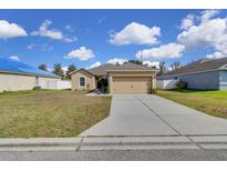 Charming single-story home with a well-maintained lawn and inviting curb appeal at 561 Lake Cummings Way, Lake Alfred, FL 33850
