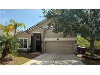 Charming two-story home featuring a well-manicured lawn and a two-car garage at 979 Hacienda Cir, Kissimmee, FL 34741