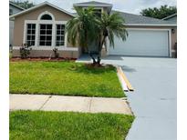 Charming single-Gathering home with well-manicured lawn and two-car garage at 2385 Andrews Valley Dr, Kissimmee, FL 34758