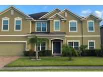 Charming two-story home features a manicured lawn, complemented by fresh landscaping and an attached two car garage at 2691 Cypress Tree Trl, St Cloud, FL 34772