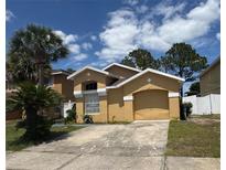 Charming single-story home with well-maintained landscaping and an attached garage at 2711 Emerson Ln, Kissimmee, FL 34743