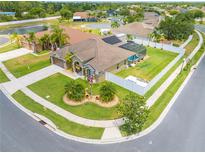 Beautiful home with a well-manicured lawn, fenced-in backyard, screened pool, and solar panels on the roof at 4301 Mohawk Ct, St Cloud, FL 34772