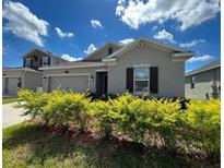 Charming single-story home featuring a well-maintained front yard and attached two-car garage at 4310 Seven Canyons Dr, Kissimmee, FL 34746