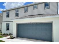 Charming two-story home with a two-car garage and well-maintained landscaping at 1148 Sugarwood St, Davenport, FL 33837