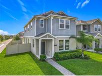 Charming two-story home featuring manicured lawn and a quaint, covered front porch, perfect for curb appeal at 1373 Williams Rd, Winter Garden, FL 34787