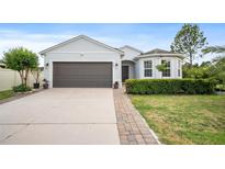 Charming single-story home featuring a well-manicured lawn and a spacious driveway at 1688 Tamarind Rd, Davenport, FL 33896