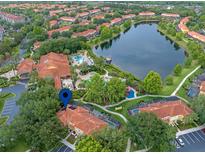 Beautiful community aerial view featuring a large lake, swimming pool, clubhouse, and well-maintained landscaping at 3015 Yellow Lantana Ln, Kissimmee, FL 34747