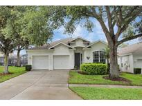 Charming single-Gathering home featuring a well-maintained lawn, mature trees, and a spacious three-car garage at 7745 Comrow St, Kissimmee, FL 34747