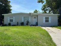 Charming single-story home featuring a well-maintained lawn and a classic concrete driveway at 921 Alecon Dr, Orlando, FL 32808