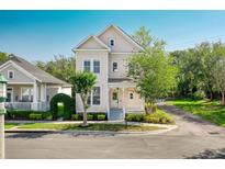 Charming two-story home featuring a covered front porch, landscaped yard, and inviting curb appeal at 121 Longview Ave, Celebration, FL 34747