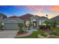 Charming single-story home boasts a well-manicured lawn and inviting front entrance with lush landscaping at 12445 Bohannon Blvd, Orlando, FL 32824