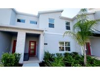 Stylish two-story townhouse featuring modern architectural details and lush landscaping at 2605 Scrapbook St, Kissimmee, FL 34746