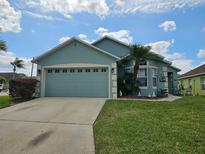 Charming single-story home featuring a well-maintained lawn, two-car garage, and delightful curb appeal at 307 Fox Loop, Davenport, FL 33837