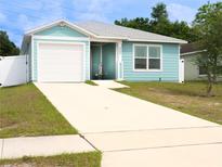 Charming single-story home with a one-car garage and a well-manicured front yard at 5506 Glen Lake Ln, Orlando, FL 32808