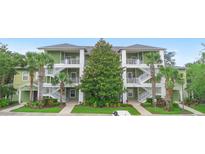 Inviting green condo building featuring white stairways, palm trees and well-maintained landscaping at 607 Gran Bahama Blvd # B29/U607, Davenport, FL 33897
