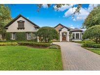 Charming one-story home with lush landscaping and a paved driveway at 6761 Valhalla Way, Windermere, FL 34786