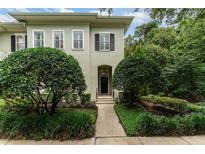 Charming home entrance with manicured bushes along the walkway to the door and a wreath at 1321 Artisan E Ave, Celebration, FL 34747