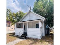 Charming home with a covered front porch and a well-maintained yard at 1413 11Th St, St Cloud, FL 34769