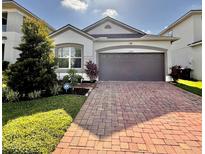 Charming single-Gathering home with well-maintained landscaping and a brick paved driveway at 2547 Trielle Ave, Kissimmee, FL 34741